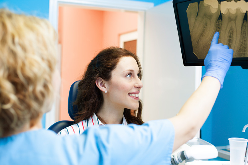 Doctor examining x-ray with patient